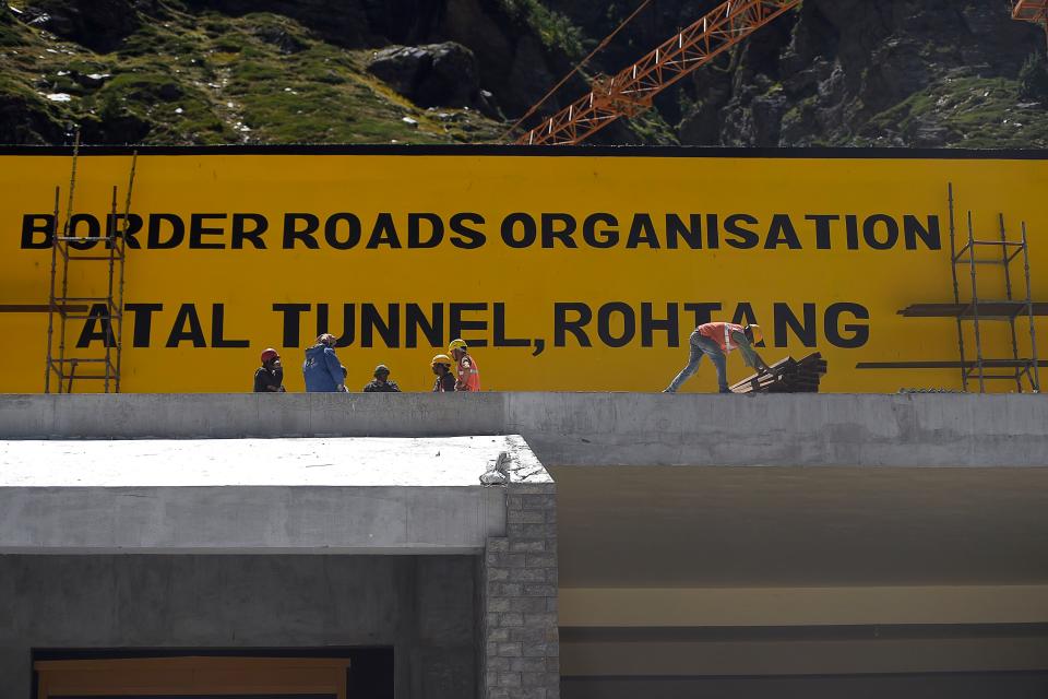 In this photograph taken on September 1, 2020, labourers work at the north portal of the Atal Rohtang Tunnel in Teling village in Lahaul and Spiti district of Himachal Pradesh state. - In India's high north, a tunnel is near completion that will slash the time needed to rush troops to the Chinese border, part of a blitz on infrastructure -- and much else besides -- near the frontier as tensions run high. (Photo by Money SHARMA / AFP) / TO GO WITH 'India-China-conflict-border-tunnel', FOCUS by Bhuvan BAGGA (Photo by MONEY SHARMA/AFP via Getty Images)