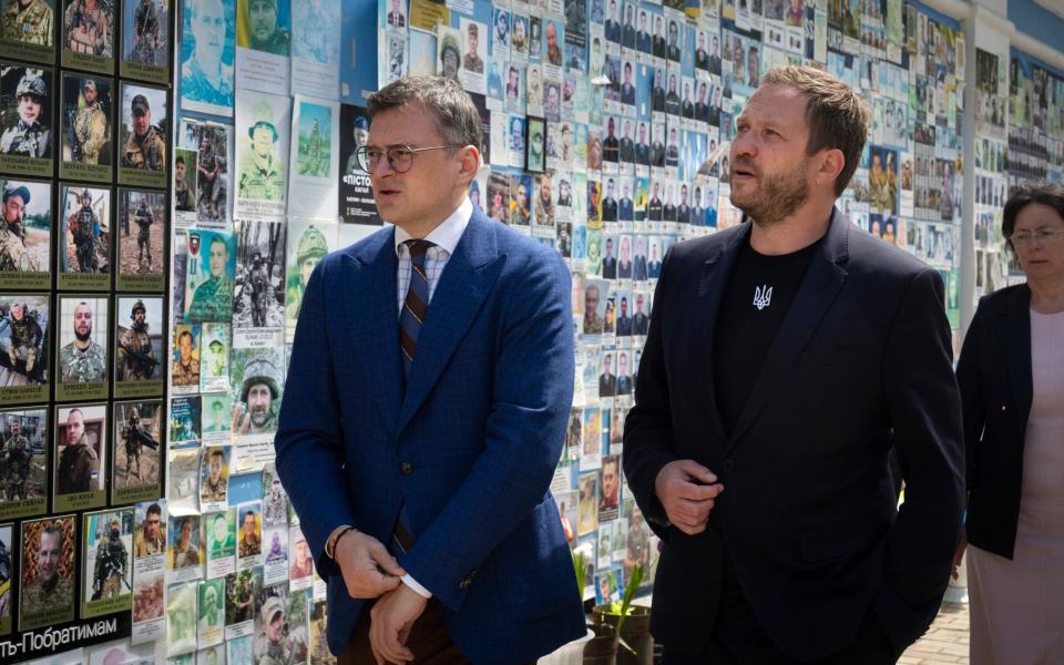 Dmytro Kuleba, Ukraine's foreign minister, speaks to Estonian counterpart after placing flowers at a memorial for fallen soldiers