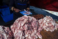 <p>Meat is sold on the streets of Khayelitsha, one of the poorest areas of Cape Town. In South Africa, says Aaron Motsoaledi, the country’s minister of health, “Obesity is caused by the rapid shift to urban living combined with increased consumption of Western-style diets high in sugar, fat, and salt. The problem is worsened in South Africa since it is a nation with a love of meat barbecued on the <em>braai,</em> cutting across ethnic boundaries; the two groups hit hardest by obesity are white Afrikaner males and black urban females.” (Photograph by Silvia Landi) </p>