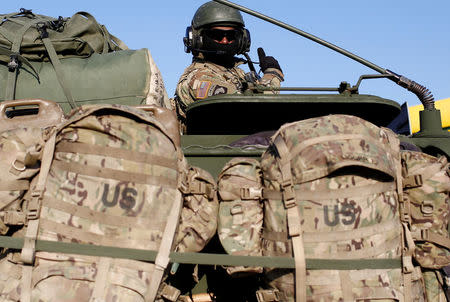 A soldier from a convoy of U.S. troops, a part of NATO's reinforcement of its eastern flank, who are on their way from Germany to Orzysz in northeast Poland, drives through Sulejowek towards a military base in Wesola, near Warsaw, Poland, March 28, 2017. REUTERS/Kacper Pempel