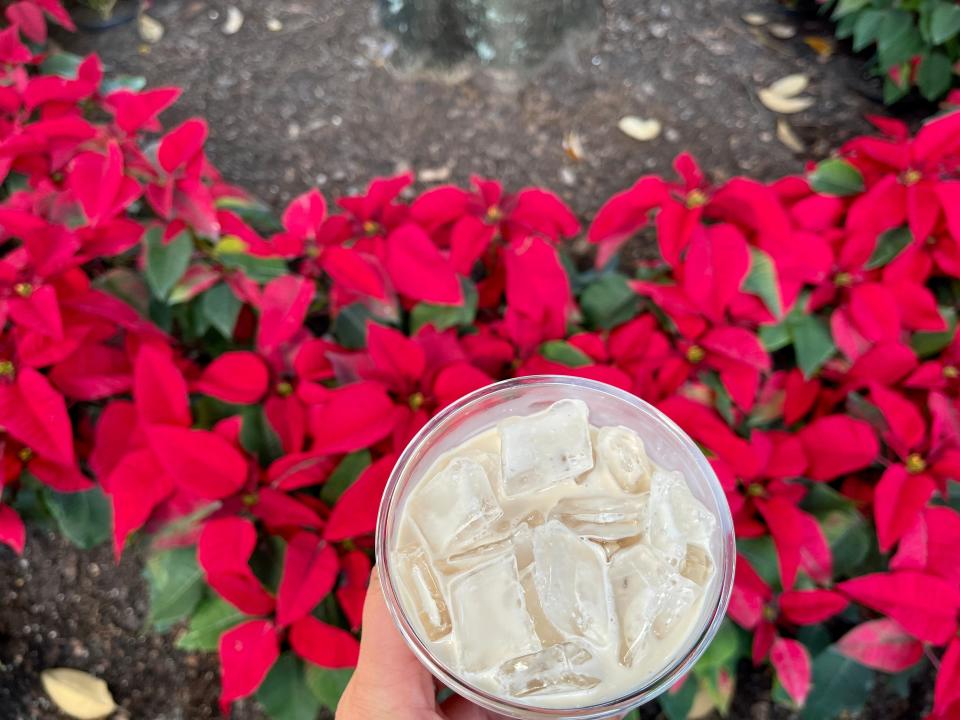 hand holding cup of eggnog at universal orlando holiday food and drink festival