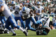 Detroit Lions' Kerryon Johnson (33) rushes over Philadelphia Eagles' Brandon Graham (55) during the first half of an NFL football game Sunday, Sept. 22, 2019, in Philadelphia. (AP Photo/Michael Perez)