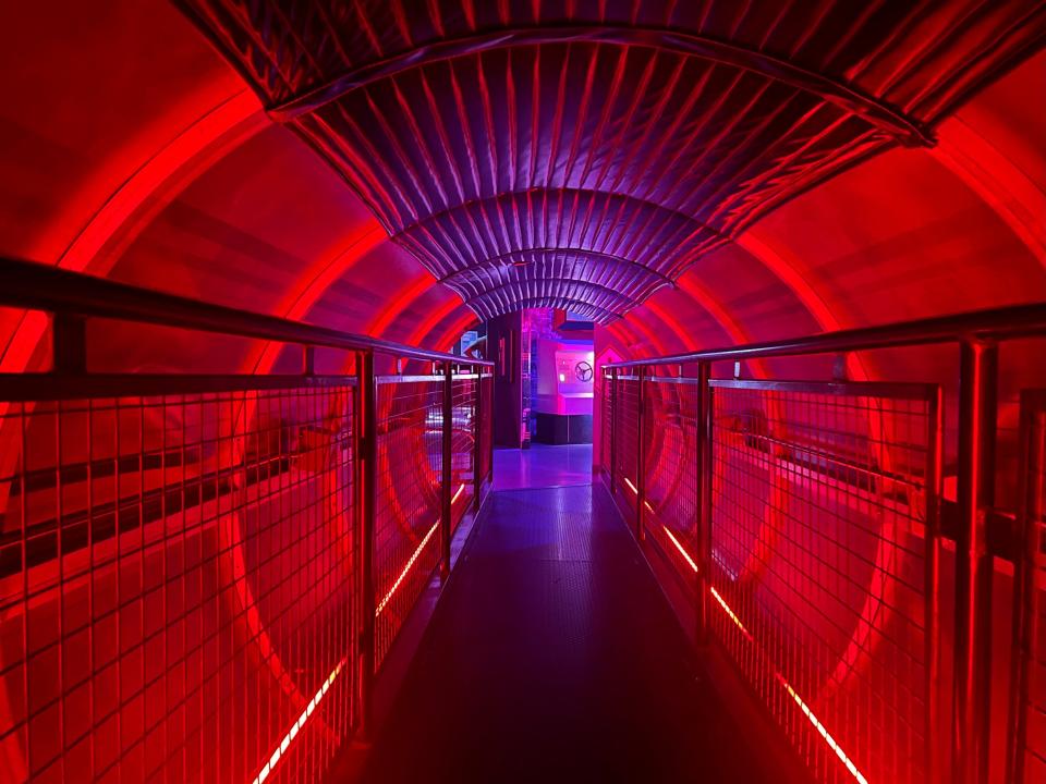 A red-lit tunnel inside Omega Mart.