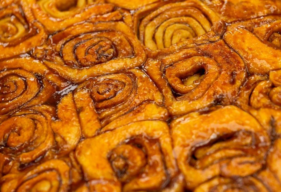 Cinnamon rolls are prepared at Knaus Berry Farm during opening day in Homestead on Tuesday, Oct. 26, 2021.