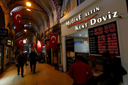 Merchants chat in front of a currency exchange office at the historical Grand Bazaar, known as the Covered Bazaar, in Istanbul, Turkey, January 12, 2017. Picture taken January 12, 2017. REUTERS/Murad Sezer