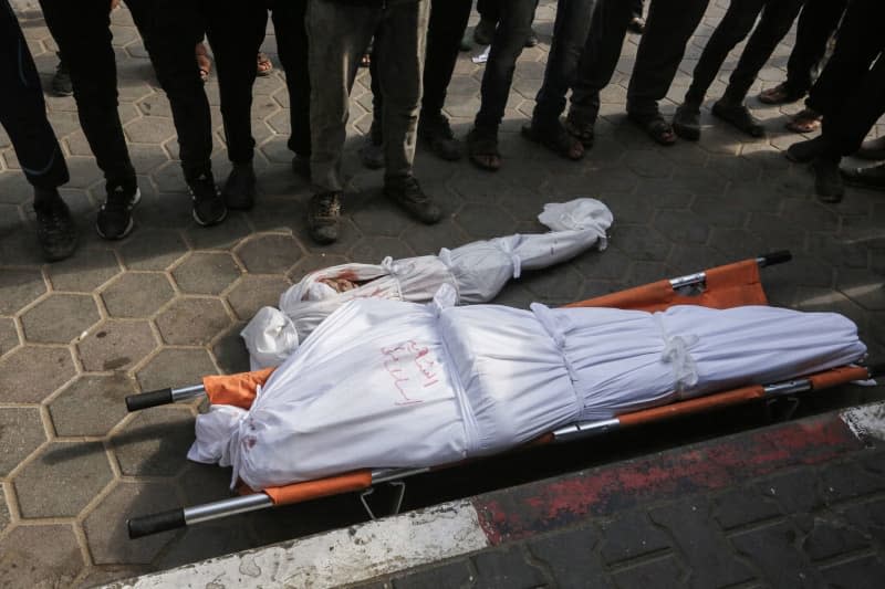 Palestinians perform funeral prayers for their relatives at the Aqsa Martyrs Hospital in Deir el-Balah who were killed in Israeli bombardments in the central Gaza Strip, amid the ongoing Israeli war in Gaza. Omar Ashtawy/APA Images via ZUMA Press Wire/dpa