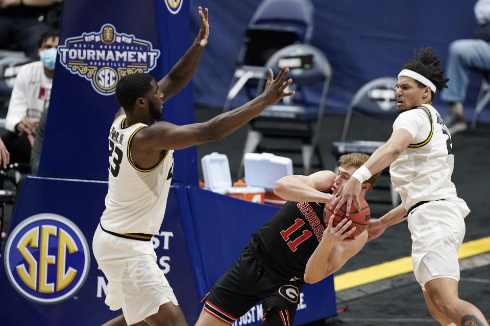 Georgia's Jaxon Etter (11) is trapped between Missouri's Jeremiah Tilmon (23) and Drew Buggs, right, in the second half of an NCAA college basketball game in the Southeastern Conference Tournament Thursday, March 11, 2021, in Nashville, Tenn. (AP Photo/Mark Humphrey)