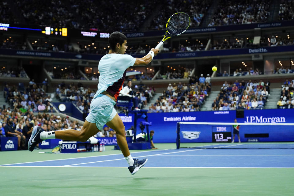 Carlos Alcaraz, of Spain, returns a shot to Frances Tiafoe, of the United States, during the semifinals of the U.S. Open tennis championships, Friday, Sept. 9, 2022, in New York. (AP Photo/Matt Rourke)