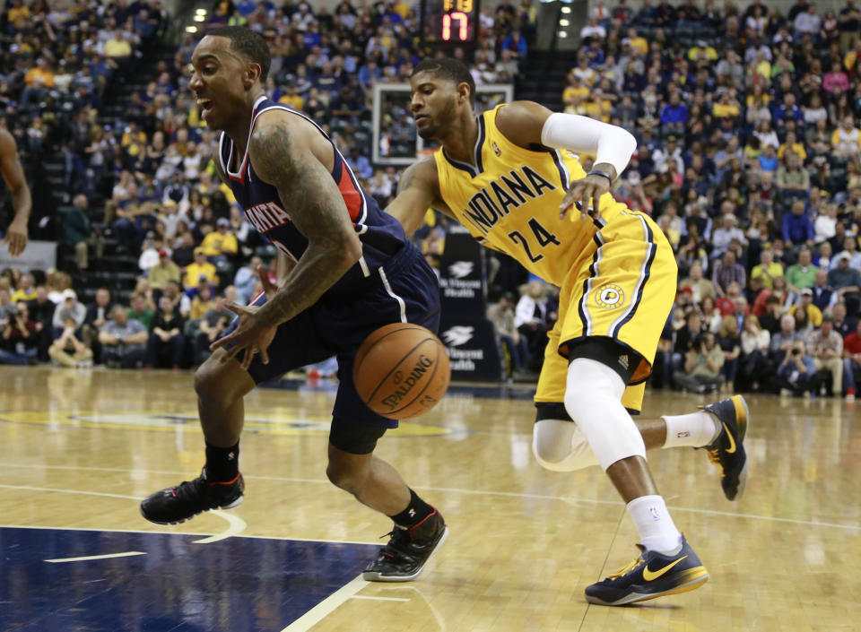 Indiana Pacers forward Paul George (24) tips the basketball away from Atlanta Hawks guard Jeff Teague in the first half of an NBA basketball game in Indianapolis, Sunday, April 6, 2014. (AP Photo/R Brent Smith)