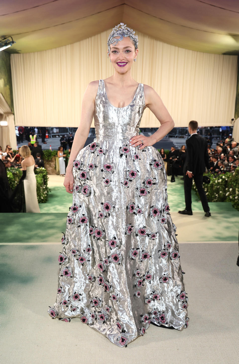 Amanda Seyfried in a sequined gown with floral accents at an event