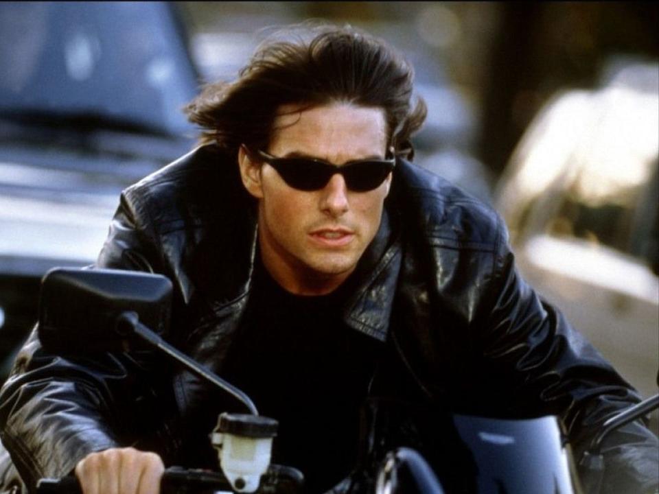 Tom Cruise in "Mission: Impossible II" riding a motorcycle with sunglasses