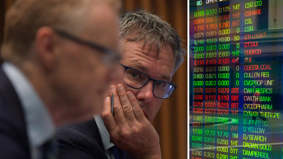 The RBA's deputy governor Guy Debelle in focus in the background with the RBA governor Philip Lowe in the foreground out of focus and the ASX board showing company price movements.