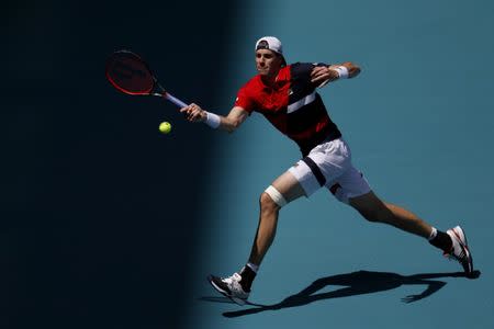 Mar 26, 2019; Miami Gardens, FL, USA; John Isner of the United States hits a forehand against Kyle Edmund of Great Britain (not pictured) in the fourth round of the Miami Open at Miami Open Tennis Complex. Mandatory Credit: Geoff Burke-USA TODAY Sports