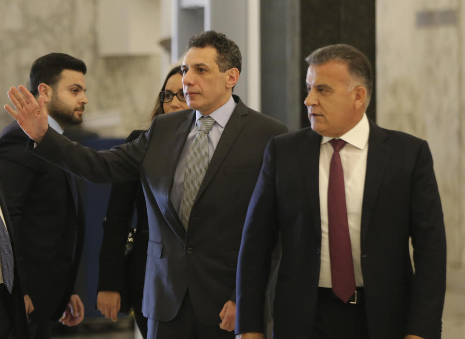 Nizar Zakka, center, a Lebanese citizen and U.S. permanent resident, who was released in Tehran after nearly four years in jail on charges of spying, walks next to Maj. Gen. Abbas Ibrahim, right, chief of Lebanese General Security Directorate, on his arrival to the presidential palace, in Baabda, east of Beirut, Tuesday, June 11, 2019. Zakka was allowed to fly to Lebanon, a development that comes amid heightened tensions between Iran and the U.S. after President Donald Trump withdrew America from Tehran's nuclear deal with world powers. (AP Photo/Hussein Malla)