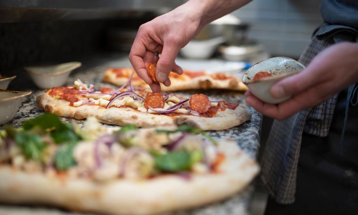 <span>Part-timer terrorism has seen an employee at a pizza chain picking their nose and rubbing their finger on raw pizza dough. </span><span>Photograph: Monty Rakusen/Getty Images</span>