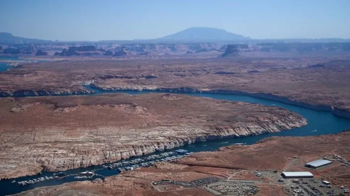 Boats are seen in low water at the Antelope Point Marina in Lake Powell on the Colorado River in Page, Arizona, on September 4, 2022. - More than two decades of severe drought have left the Colorado River and its second-largest reservoir, Lake Powell, at critical levels, as climate change leads to increased heat and decreased precipitation.