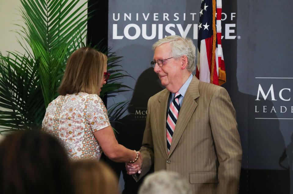 Sen. Mitch McConnell, right, greeted Arizona Sen. Kyrsten Sinema as she took the stage to make remarks about bipartisanship during an event at the McConnell Center on the campus of the University of Louisville in Louisville, Ky. on Sept. 26, 2022.  