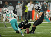 Jacksonville Jaguars kicker Matthew Wright (15), right, kicks a field goal to win the match during the second half of an NFL football game between the Miami Dolphins and the Jacksonville Jaguars at the Tottenham Hotspur stadium in London, England, Sunday, Oct. 17, 2021. (AP Photo/Matt Dunham)