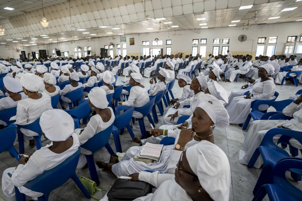 The congregation attendsa church service at the Celestial Church of Christ in the Makoko area of Lagos, Nigeria Sunday, Feb. 26, 2023. People were still voting across Nigeria Sunday morning, the day after Africa's most populous nation was supposed to have completed elections, as logistical and security challenges caused widespread delays. (AP Photo/Ben Curtis)