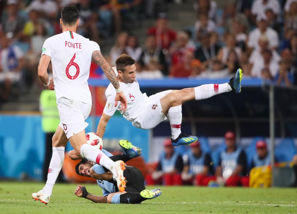 <p>Raphael Guerreiro of Portugal tangles with Uruguay’s Luis Suarez in their Round of 16 World Cup clash </p>