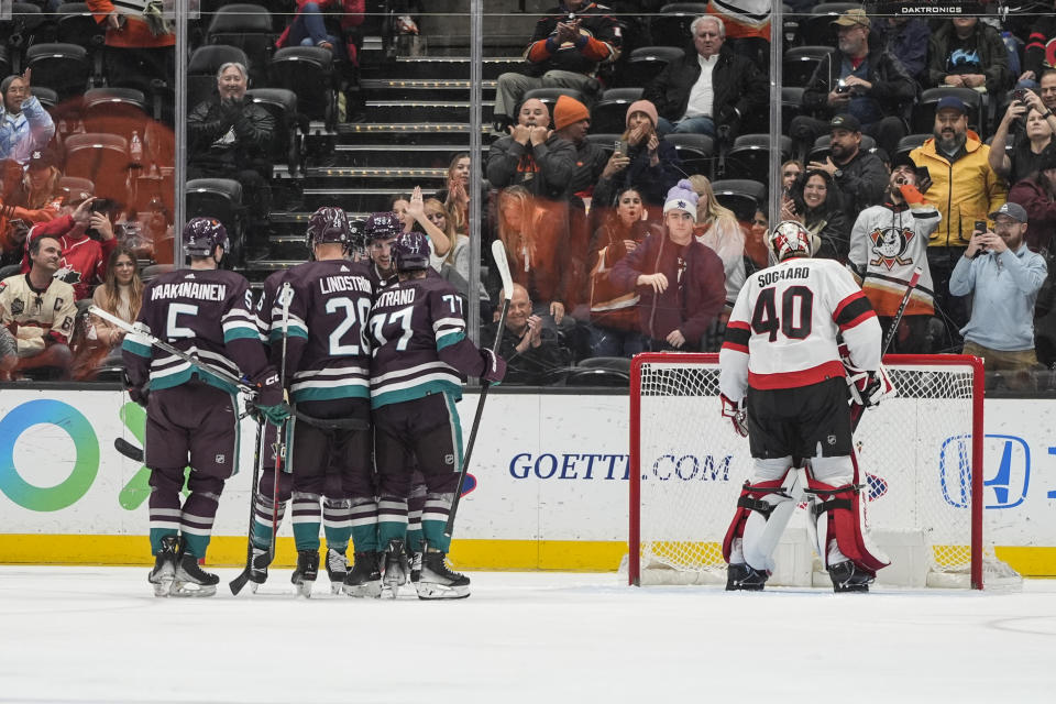 Anaheim Ducks players celebrate a goal by Ryan Strome next to Ottawa Senators goaltender Mads Sogaard (40) during the second period of an NHL hockey game Wednesday, March 6, 2024, in Anaheim, Calif. (AP Photo/Jae C. Hong)