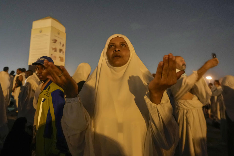 Muslim pilgrims offer prayers at top of the rocky hill known as the Mountain of Mercy, on the Plain of Arafat, during the annual Hajj pilgrimage, near the holy city of Mecca, Saudi Arabia, Saturday, June 15, 2024. Masses of Muslims gathered at the sacred hill of Mount Arafat in Saudi Arabia for worship and reflection on the second day of the Hajj pilgrimage. The ritual at Mount Arafat, known as the hill of mercy, is considered the peak of the Hajj. It's often the most memorable event for pilgrims, who stand shoulder to shoulder, asking God for mercy, blessings, prosperity and good health. Hajj is one of the largest religious gatherings on earth.(AP Photo/Rafiq Maqbool)