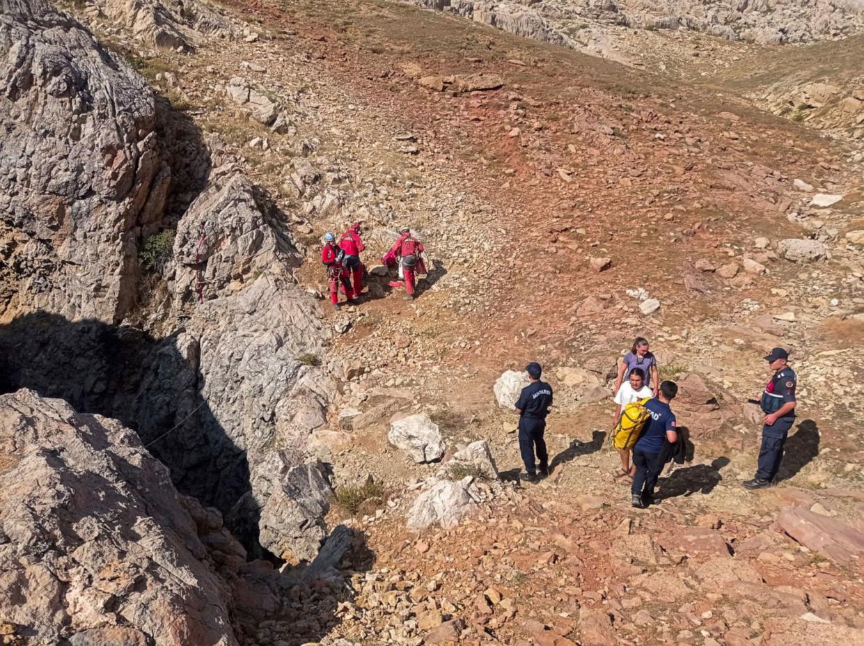 PHOTO: European Cave Rescue Association (ECRA) members and Turkish gendarmerie officers stand next to the entrance of Morca cave near Anamur, southern Turkey, Sept. 7, 2023. (Mithat Unal/Dia Images via AP)