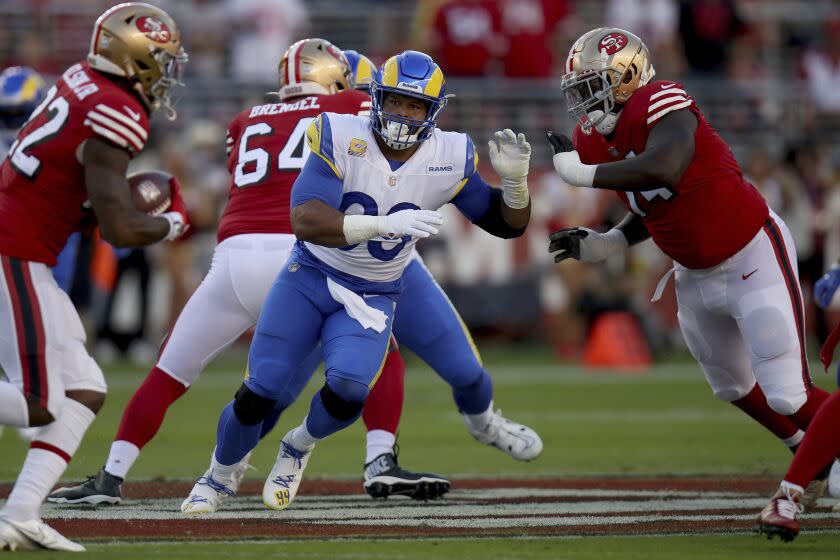 Los Angeles Rams defensive tackle Aaron Donald (99) fights off a blocker during an NFL football game.