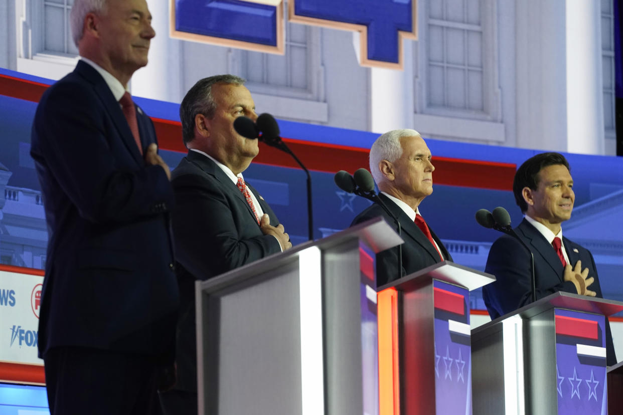 Republican presidential candidates, from left, former Arkansas Gov. Asa Hutchinson, former New Jersey Gov. Chris Christie, former Vice President Mike Pence, and Florida Gov. Ron DeSantis stand on stage before a Republican presidential primary debate hosted by FOX News Channel Wednesday, Aug. 23, 2023, in Milwaukee. (AP Photo/Morry Gash)