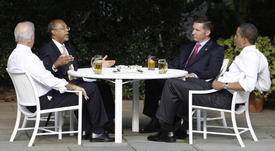 President Barack Obama, right, and Vice President Joe Biden, left, have a beer with Harvard scholar Henry Louis Gates Jr., second from left, and Cambridge, Mass., July 30, 2009. (AP Photo/Alex Brandon, File)