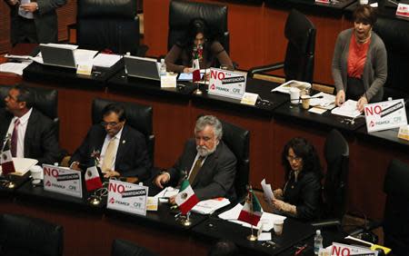 Senator Dolores Padierna (first row R) and Senator Alejandro Encinas (2nd R) of the Party of the Democratic Revolution (PRD) sit next to other senators of PRD before a debate on an energy reform bill at the Senate in Mexico City December 10, 2013. REUTERS/Henry Romero