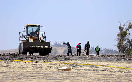 Villagers gather wreckages of the Ethiopian Airlines Flight ET 302 plane crash, near the town Bishoftu, near Addis Ababa, Ethiopia March 15, 2019. REUTERS/Tiksa Negeri