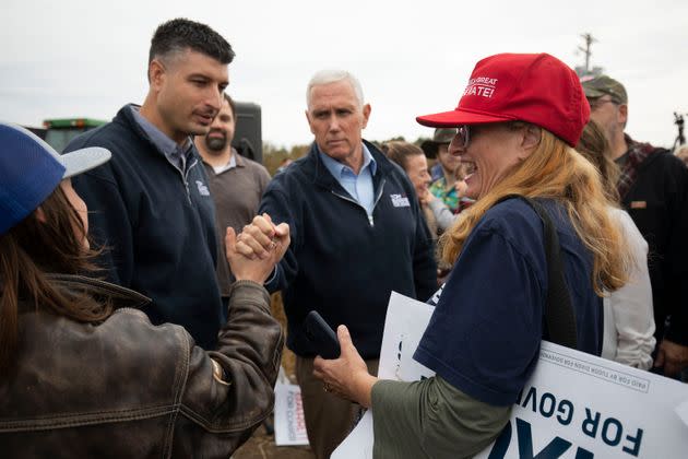 Former Vice President Mike Pence (center) campaigns with Michigan Republican congressional candidate Tom Barrett (left) at a rally on Nov. 4 in Charlotte, Michigan. (Photo: Bill Pugliano via Getty Images)