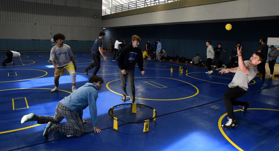 Anthony Cousino (right) hits the ball back towards the bounce net as the four wrestlers Karson Petit, Gabe Hall and Jonah Busen play spike ball at the beginning of practice Tuesday, Feb. 20, 2024. "I always want kids to be in the place they want to be," said coach Ryan Nadeau. "We have fun!"