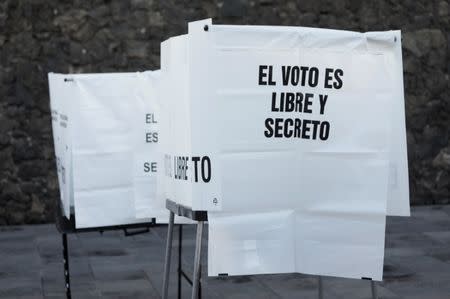 A voting booth with a sign reading: "The vote is free and secret" is seen at a polling station during the presidential election in Mexico City, Mexico July 1, 2018. REUTERS/Alexandre Meneghini