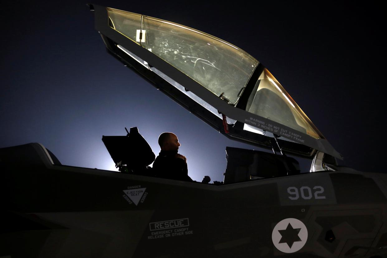 An Israeli soldier sits inside a F-35 fighter jet