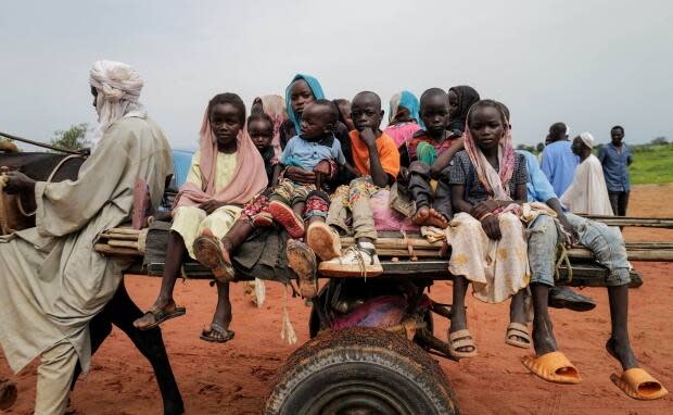 Sudanese children, who fled the conflict in Murnei in Sudan's Darfur region, ride a cart while crossing the border between Sudan and Chad in Adre, Chad, on Aug. 4, 2023. (Zohra Bensemra/Reuters)