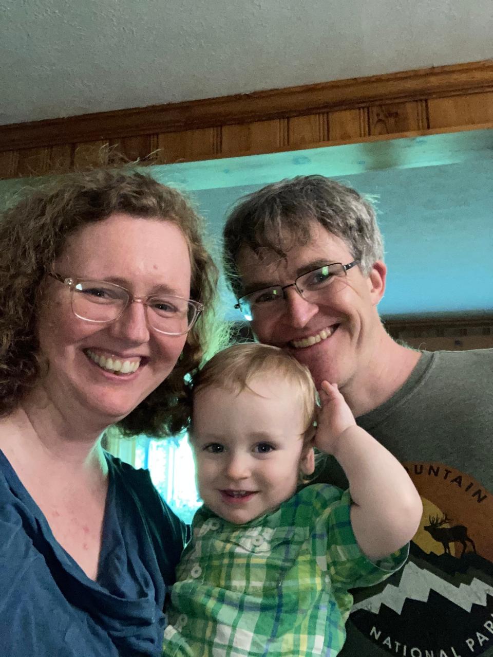 Anne Jefferson (left), a Kent State University professor, shown with her husband, Chris Rowan, and 17-month-old, Andrew Jefferson, has had trouble finding a COVID-19 vaccine appointment for the toddler.