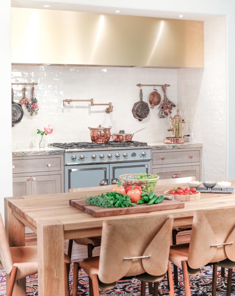 The finished kitchen nook. Zohory Wood Design did the custom cabinetry and hood. The reclaimed oak dining table is from RH, and the chairs are 1085 Edition models by Bartoli Design.