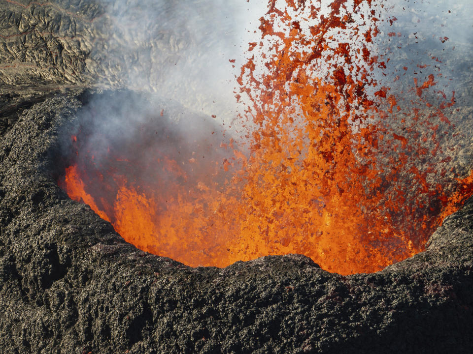 Lava erupt near the town of Grindavik, Iceland, Thursday, March 28, 2024. (AP Photo/Marco di Marco)