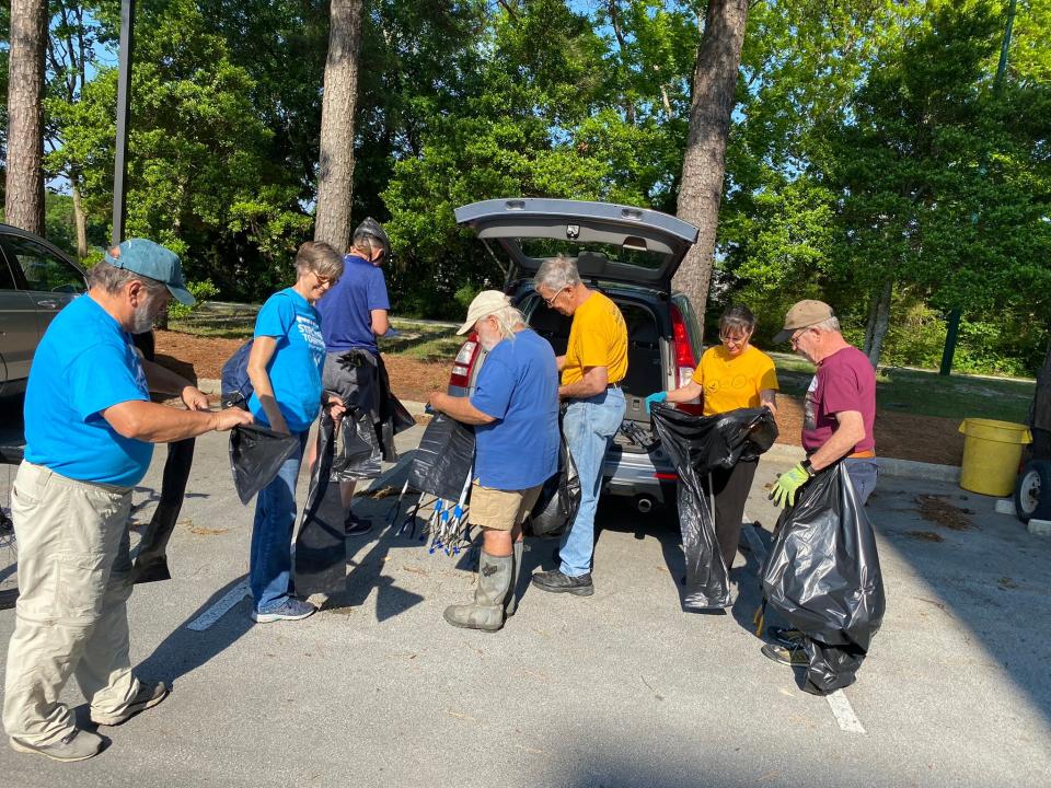 UUFNB volunteers cleaned up trash and debris in the marshland under and adjacent to the city’s new 400-foot scenic boardwalk at Lawson Creek Park.