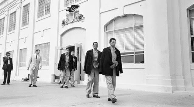 In this March 21, 1963 photo taken by Leigh Wiener and provided by the National Park Service, prison guard Jim Albright, second from left, leads out the last prisoners from the federal penitentiary.