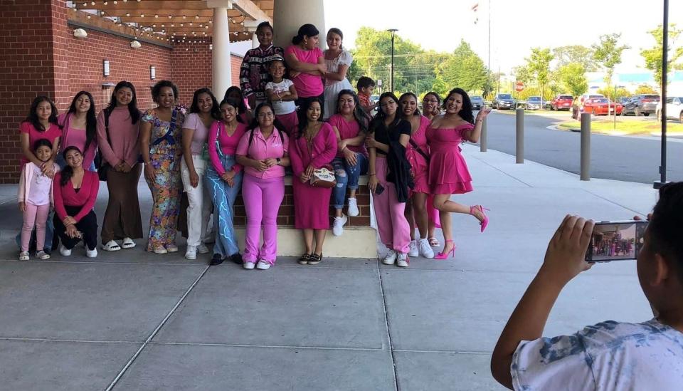 Members of Mitra church of Chesterfield strike poses after watching the Barbie movie at Cinema Cafe in Chester, Va. on July 29, 2023.