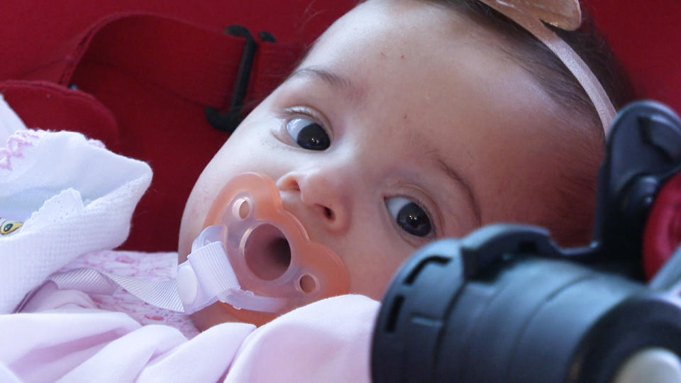 Elisa sits comfortably in her stroller