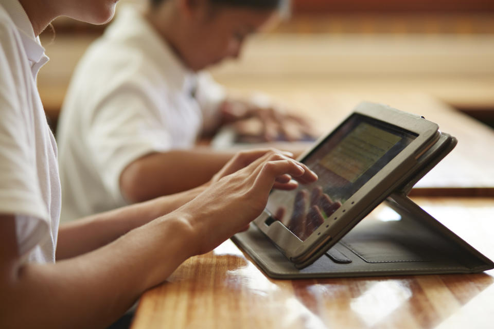 School students in class working with tablets