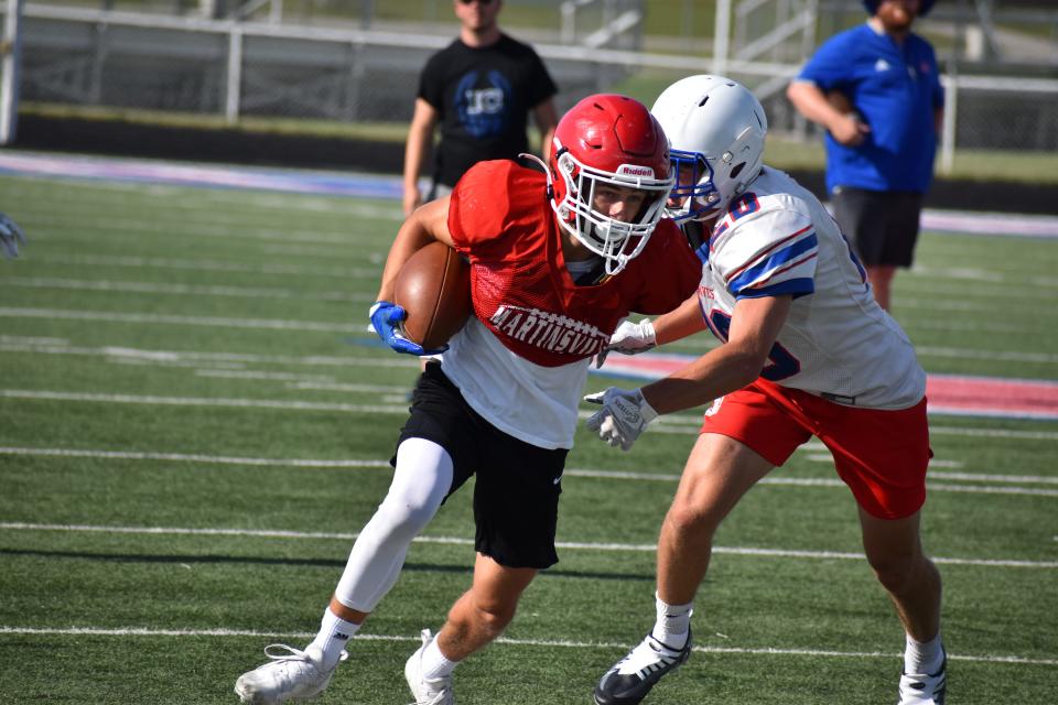 Martinsville receiver Garrett Skaggs shakes off an Indian Creek defender during the Artesians' scrimmage with the Braves on June 22, 2022.