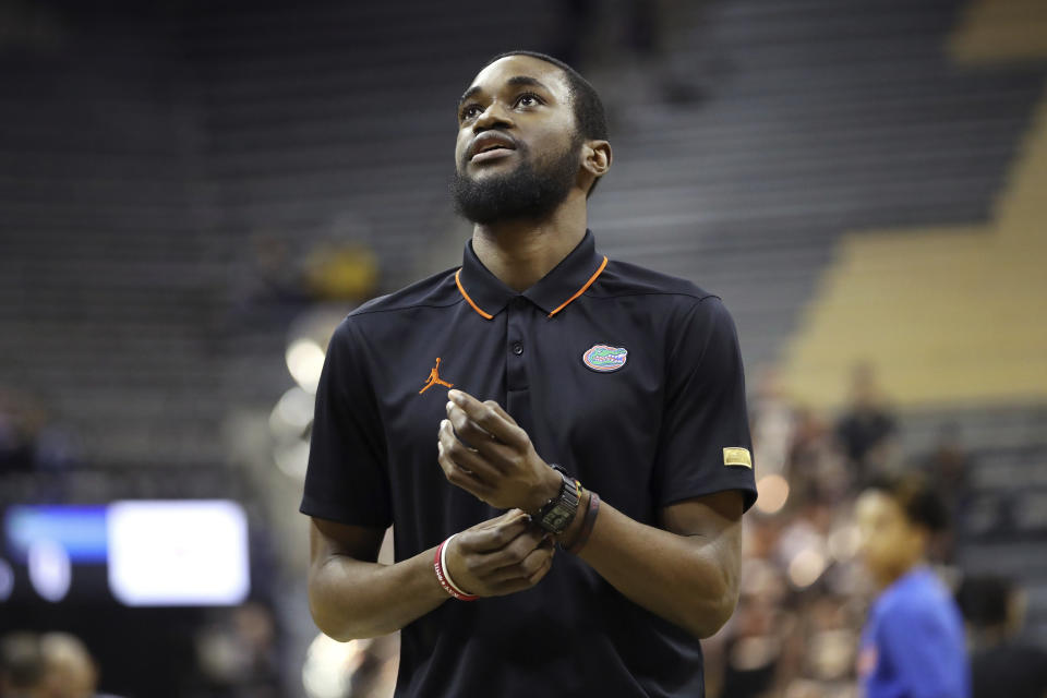 In this Jan. 11, 2020, photo provided by the University of Florida Athletic Association, Florida team manager Chris Sutherland is shown during an NCAA college basketball game against Missouri in Columbia, Mo. Sutherland waited nearly five years to finally play college basketball. He worked his way onto Florida’s bench in January after serving as an arena worker, a practice player for the women’s team and a team manager for the men’s program. Gaining NCAA eligibility was a daunting task that required him to repay a $5,000 scholarship and remove his name and likeness off a website he created last year to sell streetwear he designed. (Alex de la Osa/UAA Communications via AP)