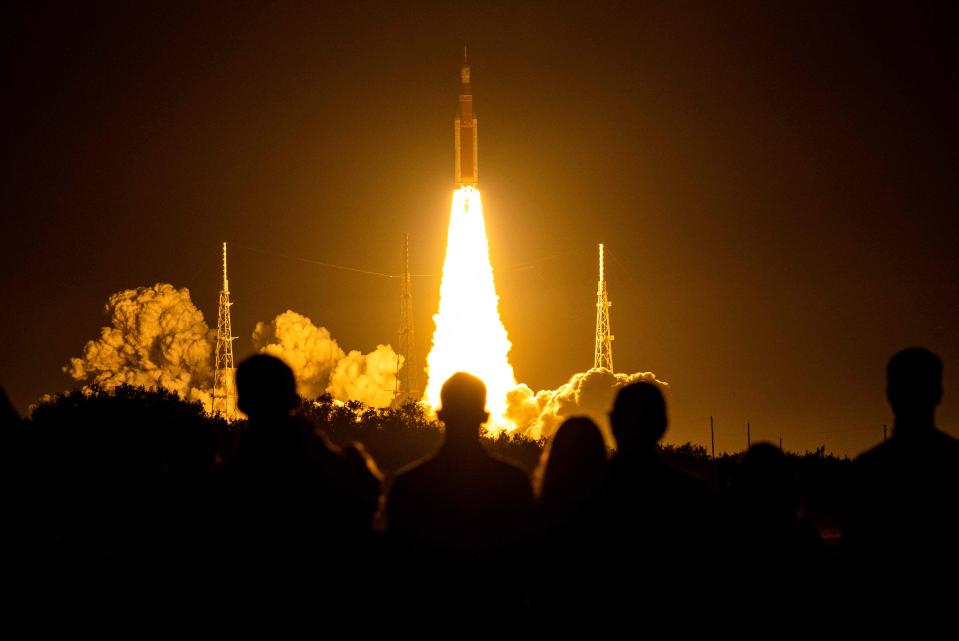 Spectators watch as the Artemis I unmanned lunar rocket lifts off from launch pad 39B at NASA's Kennedy Space Center in Cape Canaveral, Florida, on November 16, 2022.