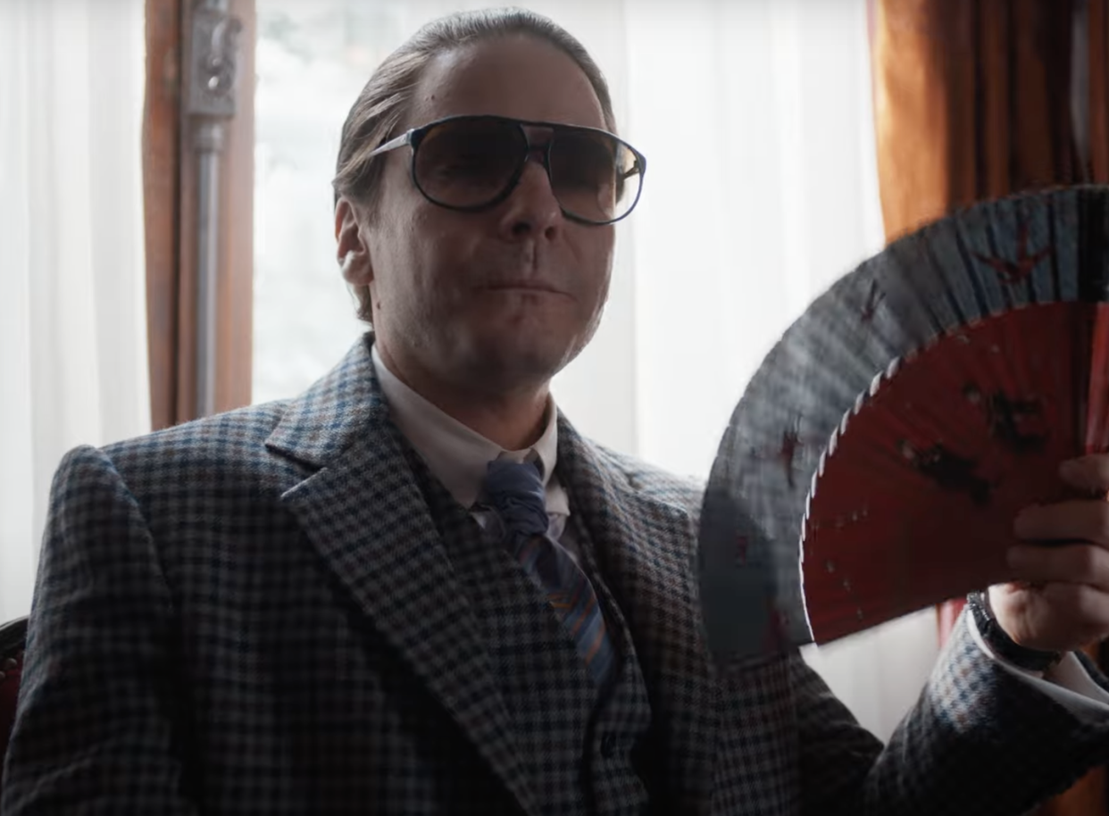 a man holding a fan