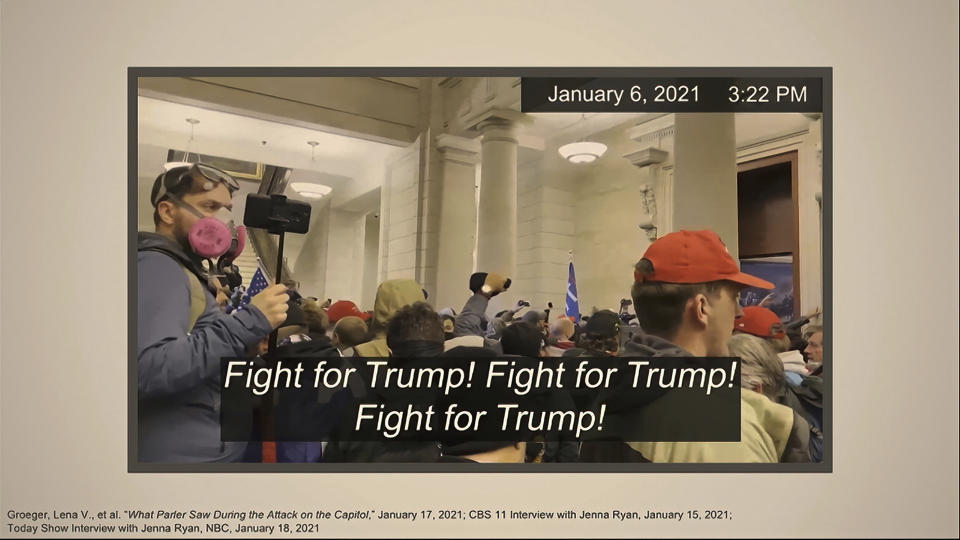 This image from video shows one of many slides presented by Democrats prosecuting the impeachment of former President Donald Trump in the Senate at the U.S. Capitol in Washington, Wednesday, Feb. 10, 2021. The video, which showed Trump's supporters chanting "Fight for Trump!" after they stormed into the U.S. Capitol on Jan. 6, was used by prosecutors as they sought to connect the mob with Trump and make the case that the president had incited them to insurrection. (Senate Television via AP)